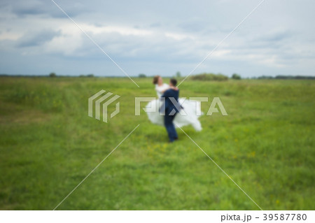Blurry romantic bride and groom 39587780