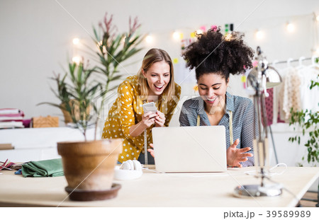 Young creative women with laptop in studio 39589989