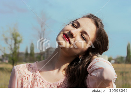Beautiful girl in a pink dress in field 39598045