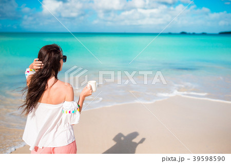 Young woman on the beach. Back view of girl with 39598590
