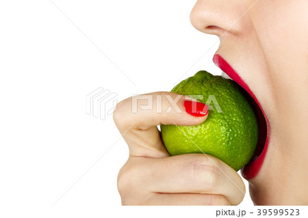 Young woman bite eat fresh lime isolated Young woman bite eat fresh lime isolated 39599523