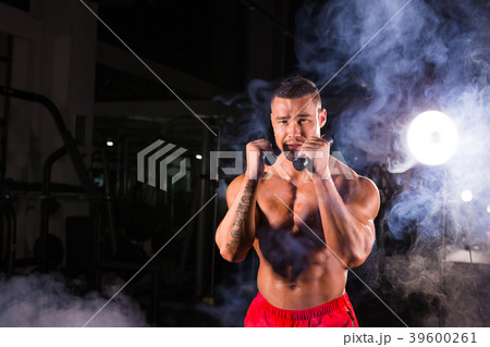 Powerful man doing boxing exercises, making direct Powerful man doing boxing exercises, making direct 39600261