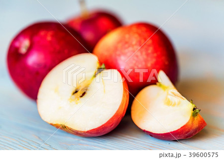 Apples whole and cut on blue wooden surface 39600575