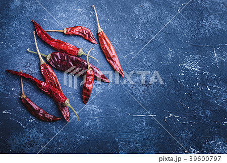 Dried chili peppers on blue concrete background Dried chili peppers on blue concrete background 39600797