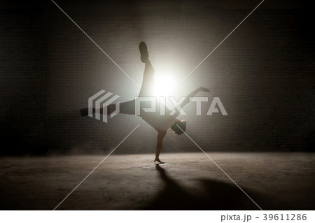 young b-boy wearing pants and singlet practising young b-boy wearing pants and singlet practising 39611286