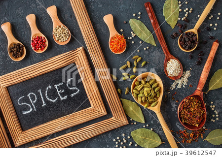 Various spices in wooden spoons on dark ston Various spices in wooden spoons on dark ston 39612547