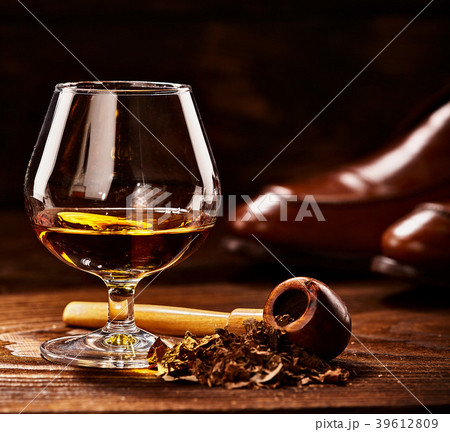 Glass of cognac and pipe with tobacco with shoes Glass of cognac and pipe with tobacco with shoes 39612809