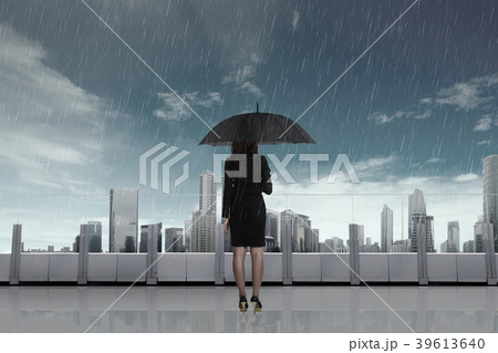 Business woman with umbrella in the rain Business woman with umbrella in the rain 39613640