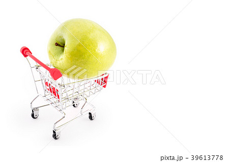 Shopping cart with big green apple on white 39613778