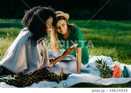 Picnic theme. Two happy beautiful smiling young 39614936