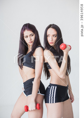 Two young sports women in shot tops and shorts 39614958