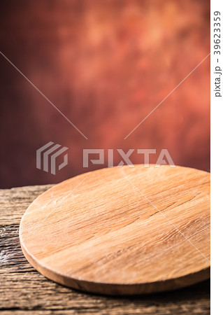 Empty pizza round board  on old wooden table. 39623359