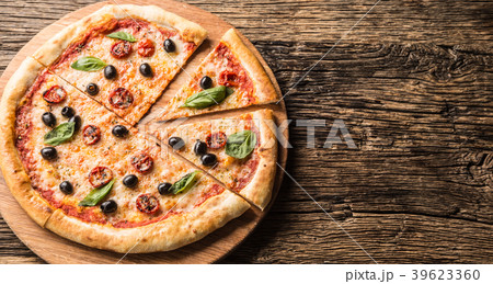 Top of wiew italian pizza on wooden plate. 39623360