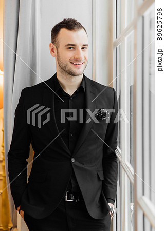 Stylish young bristle man is standing near the big 39625798