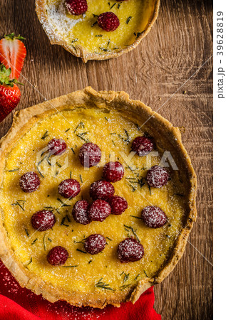 Lemon tart with rosemary and berries 39628819