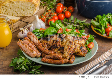 Grilled chicken wings and sausages 39630855