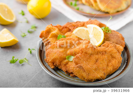 Delicious original schnitzel with potato pancakes Delicious original schnitzel with potato pancakes 39631966