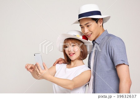 Happy young traveler couple concept photo. set out on a trip to honeymoon, camping and summer vacation concept isolated on white background. 423 Happy young traveler couple concept photo. set out on a trip to honeymoon, camping and summer vacation concept isolated on white background. 423 39632637