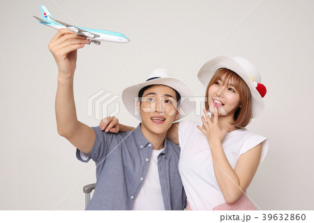 Happy young traveler couple concept photo. set out on a trip to honeymoon, camping and summer vacation concept isolated on white background. 434 Happy young traveler couple concept photo. set out on a trip to honeymoon, camping and summer vacation concept isolated on white background. 434 39632860