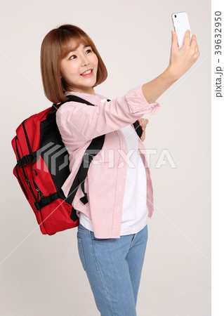 Young traveler woman with a backpack concept isolated on White photo. 086 Young traveler woman with a backpack concept isolated on White photo. 086 39632950