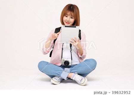 Young traveler woman with a backpack concept isolated on White photo. 104 Young traveler woman with a backpack concept isolated on White photo. 104 39632952