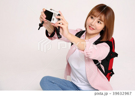 Young traveler woman with a backpack concept isolated on White photo. 080 Young traveler woman with a backpack concept isolated on White photo. 080 39632967