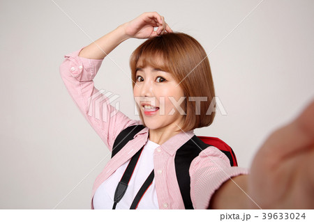 Young traveler woman with a backpack concept isolated on White photo. 057 Young traveler woman with a backpack concept isolated on White photo. 057 39633024