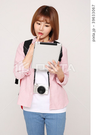 Young traveler woman with a backpack concept isolated on White photo. 101 Young traveler woman with a backpack concept isolated on White photo. 101 39633067