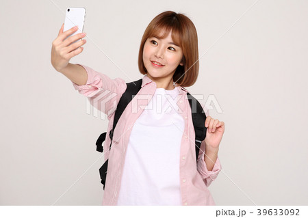 Young traveler woman with a backpack concept isolated on White photo. 082 Young traveler woman with a backpack concept isolated on White photo. 082 39633092
