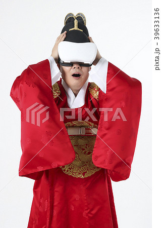 A middle-aged man who dressed a king's clothes making funny expression photo. 398 39633136