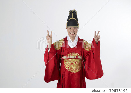 A middle-aged man who dressed a king's clothes making funny expression photo. 298 39633192