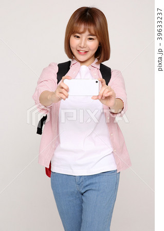 Young traveler woman with a backpack concept isolated on White photo. 094 Young traveler woman with a backpack concept isolated on White photo. 094 39633237