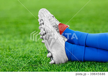 Legs of a player in football on a green lawn Legs of a player in football on a green lawn 39645686