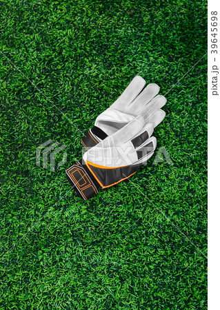 Gloves of the goalkeeper on a green lawn 39645698