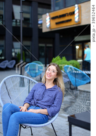 Female person sitting in chair with building 39652464