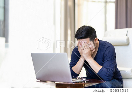 Stressed out asian man holding hand on his face. Stressed out asian man holding hand on his face. 39652515