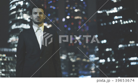 A serious young businessman dressed in a black 39653674