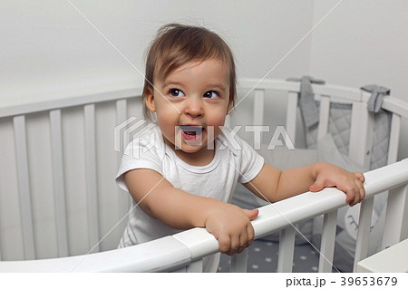 one year old child in white clothes standing in a one year old child in white clothes standing in a 39653679