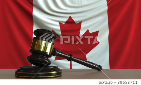 Judge's gavel and block against the flag of Canada 39653711
