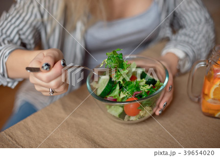 Happy young woman eats healthy vegetable salad Happy young woman eats healthy vegetable salad 39654020