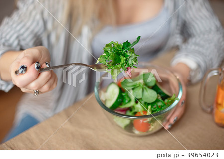 Happy young woman eats healthy vegetable salad Happy young woman eats healthy vegetable salad 39654023