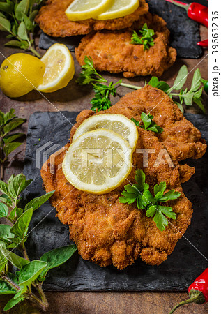 Schnitzel with fries, salad and herbs Schnitzel with fries, salad and herbs 39663236