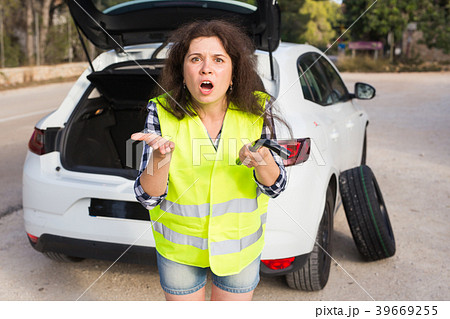 Broken down car with warning triangle. Woman Broken down car with warning triangle. Woman 39669255