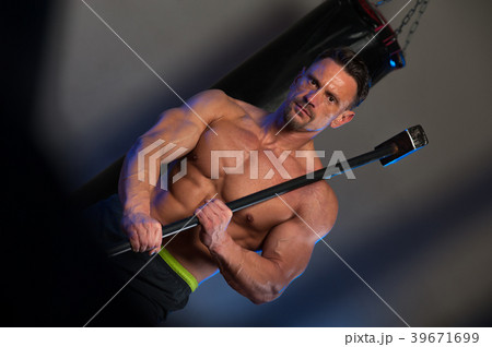 Muscular strong man training with hammer 39671699