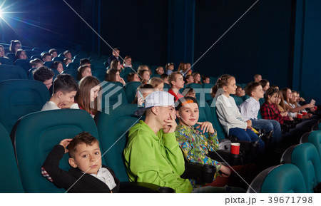 Sideview of boys watching movie in the cinema. 39671798