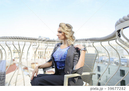 Female photo model sitting at cafe on balcony with Female photo model sitting at cafe on balcony with 39677282