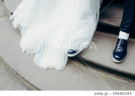 Above view at the newlywed legs on the staircases Above view at the newlywed legs on the staircases 39680284