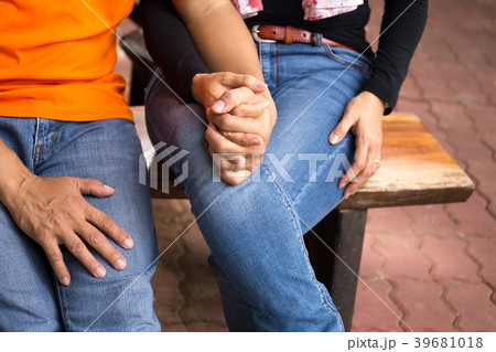 Asian couple sitting and holding hands 39681018