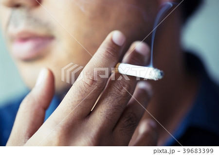 The man smoking a cigarette. Cigarette smoke  39683399