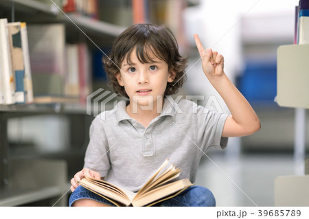 Smart boy with many book sitting on floor. 39685789
